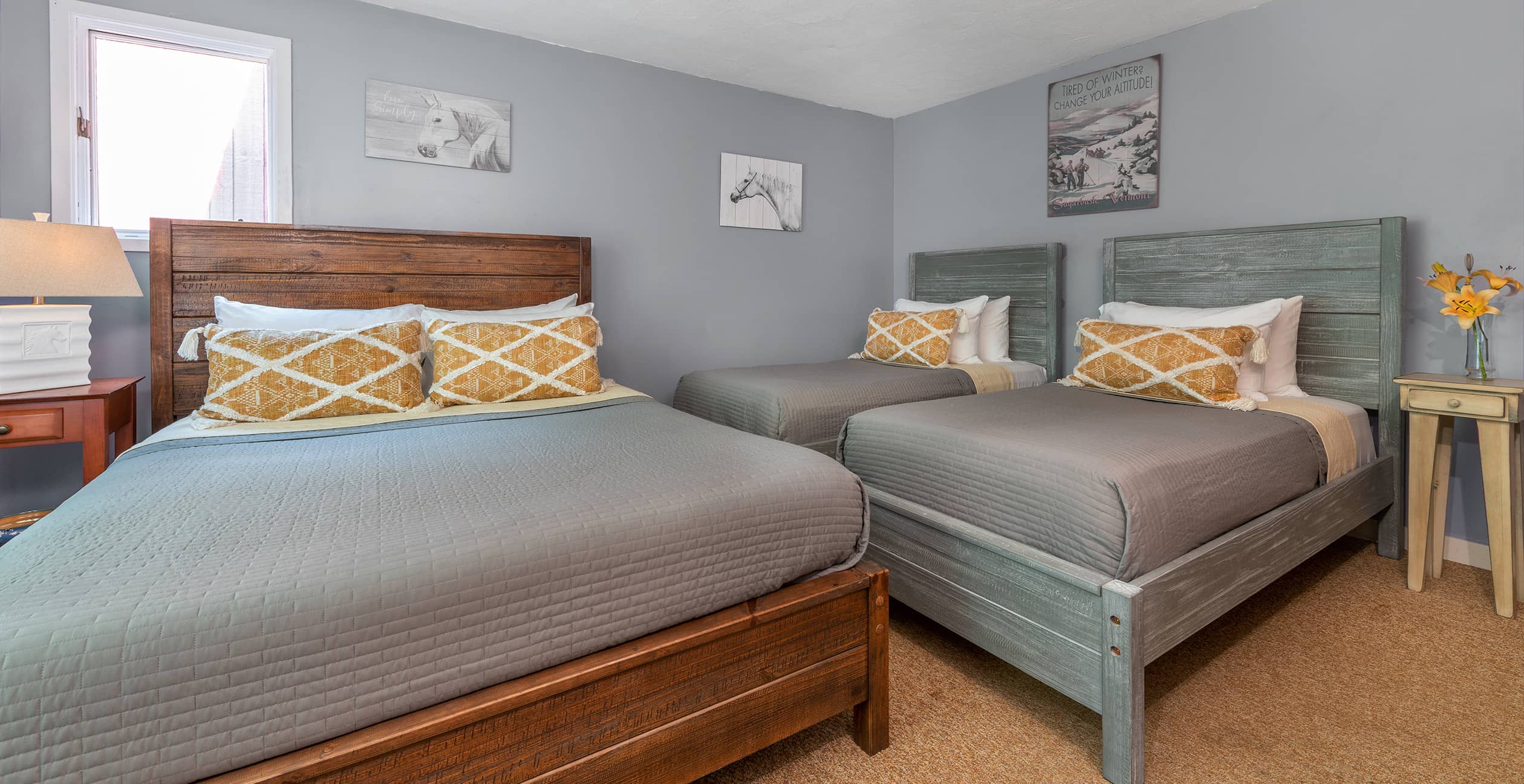 Renovated lodge room with queen and two twins at our hotel in Waitsfield, VT