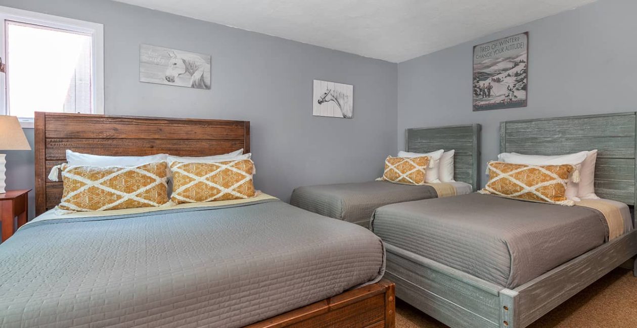 Vermont lodge room with queen bed and two twins