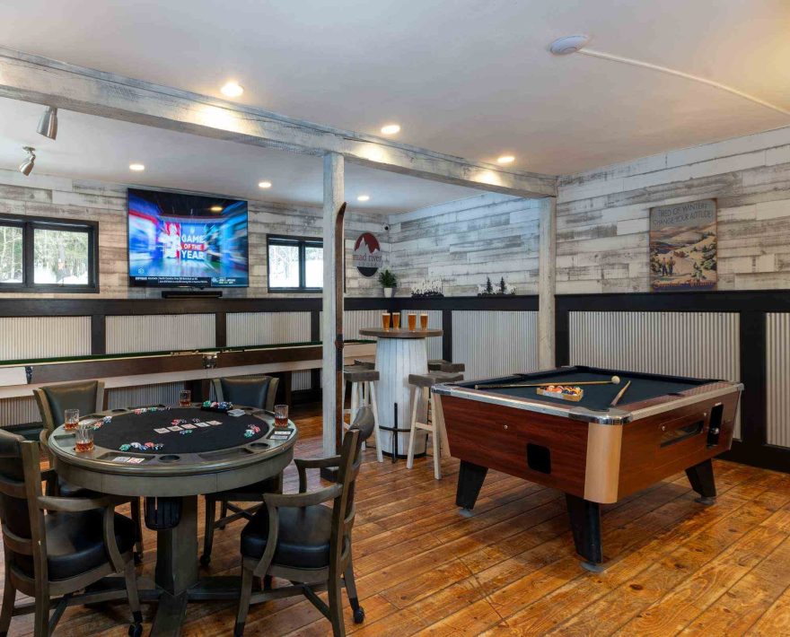 Poker table, pool table, and shuffleboard table in game room at White Horse Lodge in Vermont