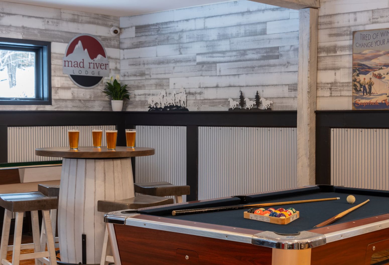 Pool table and seating in game room at White Horse Lodge in Vermont
