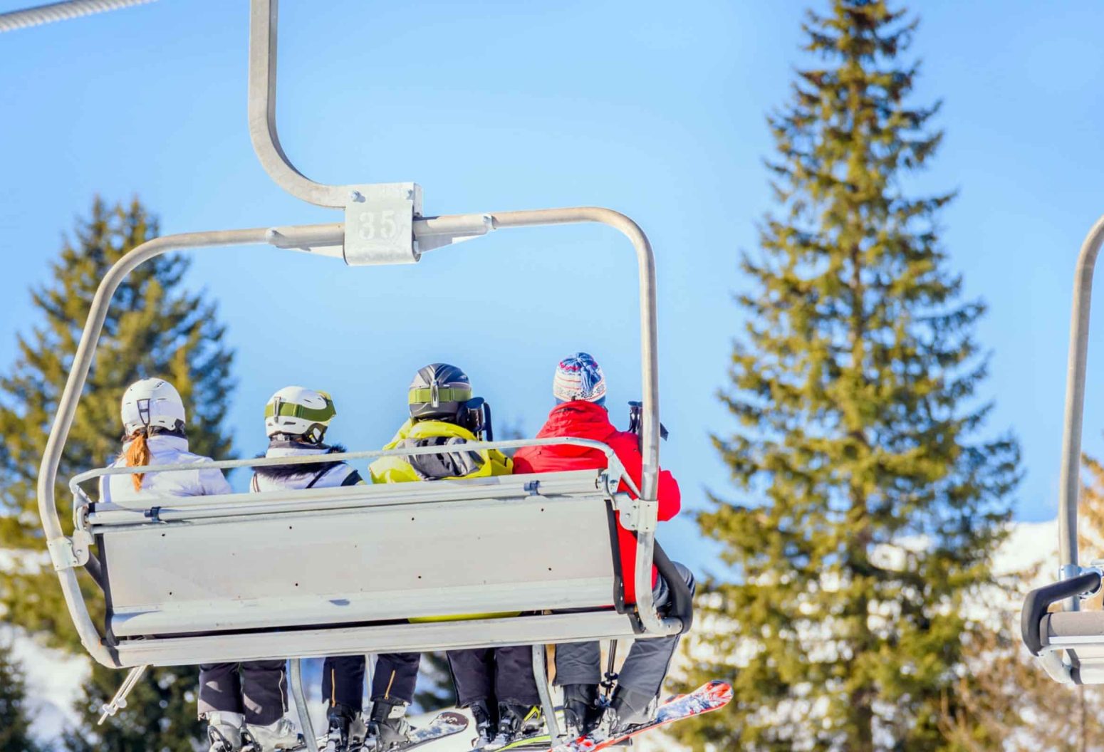 Skiers on chairlift in Vermont
